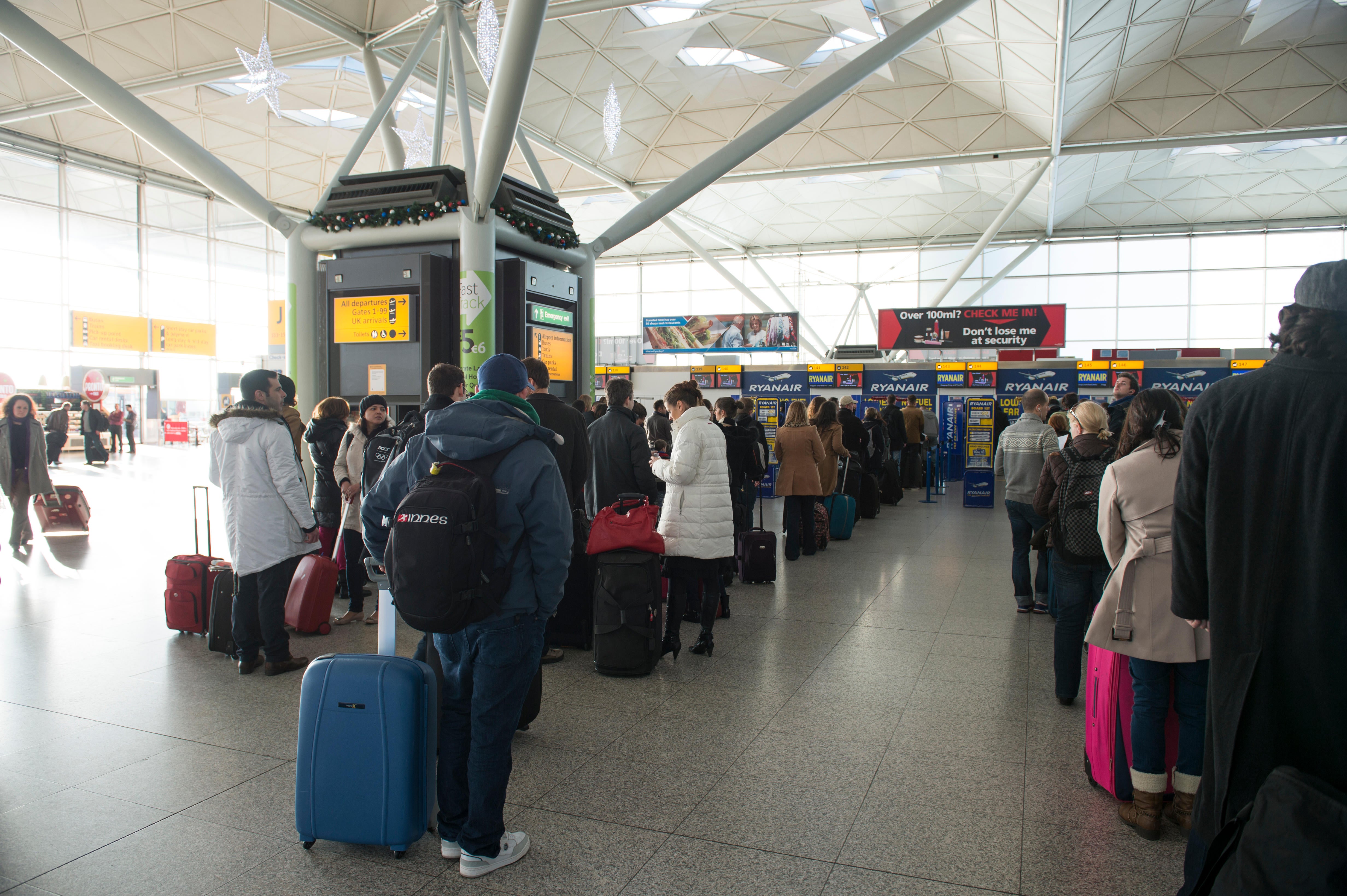 Queues at a UK airport as a staff survey suggested more than two in five were thinking of leaving the industry (Alamy/PA)