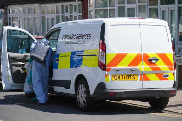 Forensic investigators near the scene in Waltham Forest in east London (Jonathan Brady/PA)