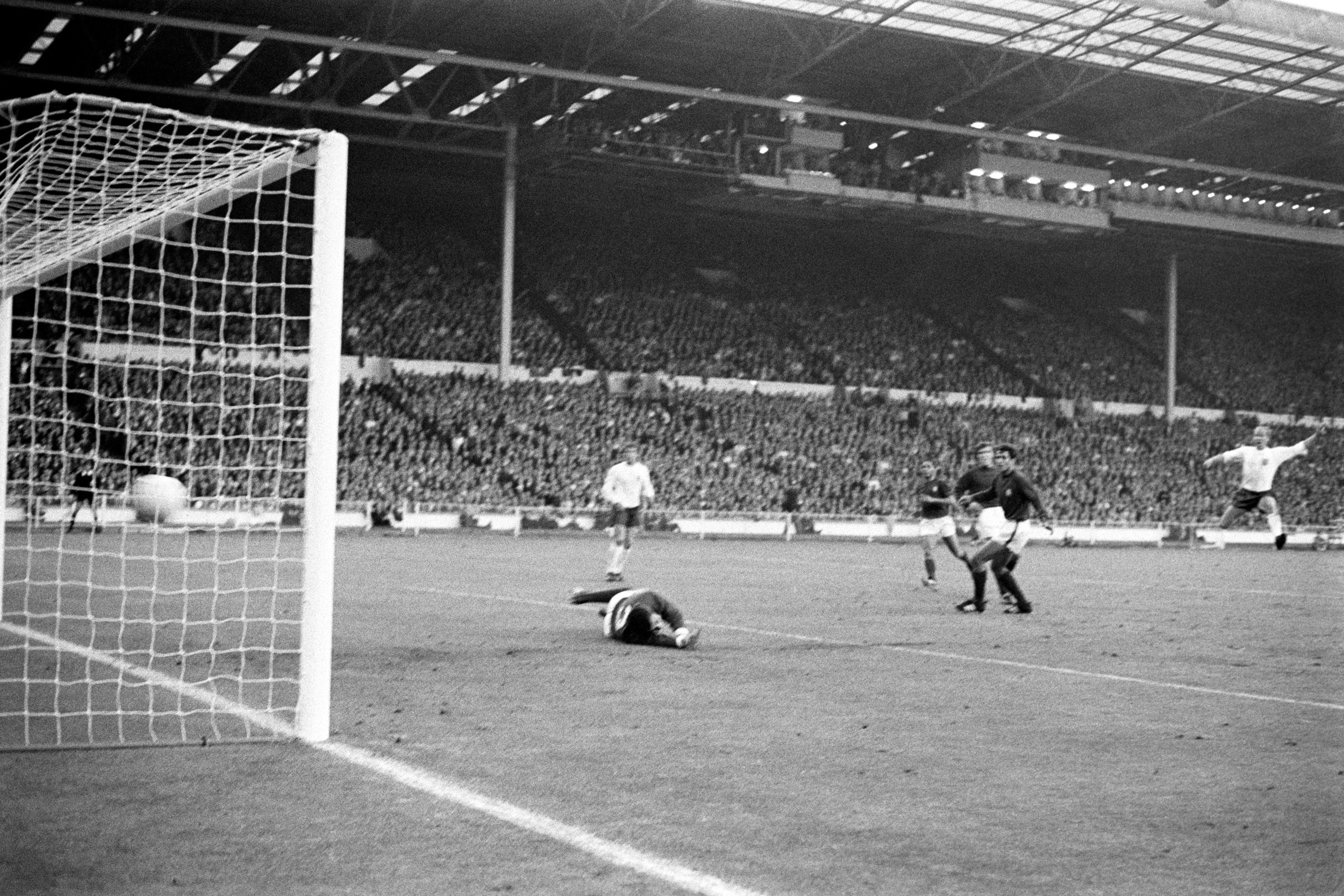 Sir Bobby Charlton, right, scores against Portugal in the 1966 World Cup semi-final (PA)