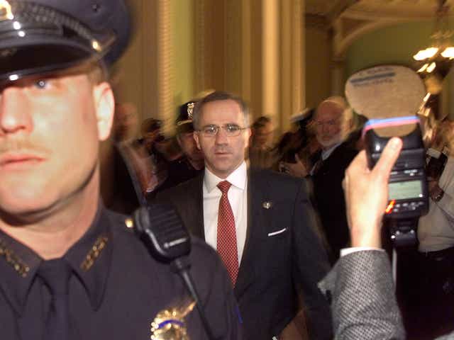 <p>Steve Buyer (R-IN) walks in the halls of the US Senate as Capitol Hill police hold back the media in the halls of the US Senate shortly before the start of the 14 January impeachment trial of US President Bill Clinton</p>
