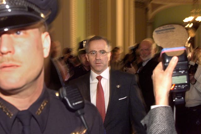 <p>Steve Buyer (R-IN) walks in the halls of the US Senate as Capitol Hill police hold back the media in the halls of the US Senate shortly before the start of the 14 January impeachment trial of US President Bill Clinton</p>