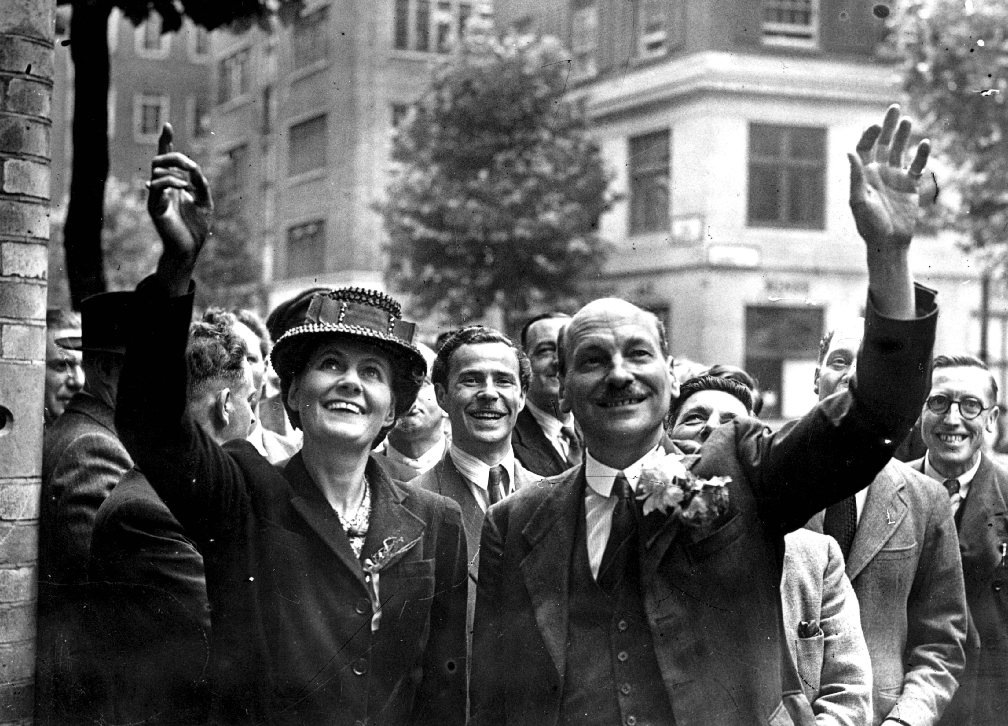 <p>Clement Attlee and his wife Violet wave to crowds in London on 26 July 1945 – the day he became prime minister </p>