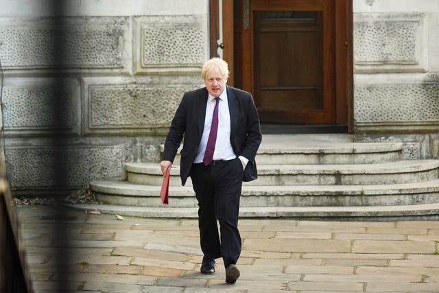Then foreign secretary Boris Johnson leaves the Foreign Office (Victoria Jones/PA)