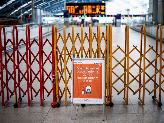 <p>A barricade is seen inside Waterloo Station during rail strikes in June</p>