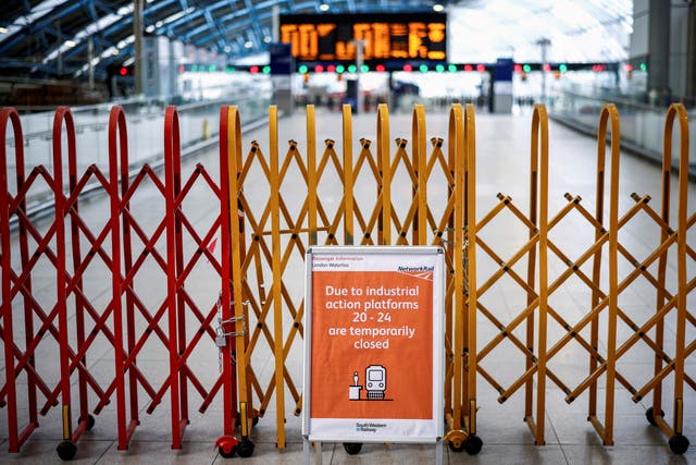 <p>A barricade is seen inside Waterloo Station during rail strikes in June</p>