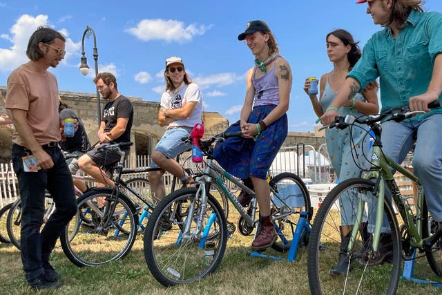<p>Concertgoers sit on stationary bikes used to power a small stage at the Newport Musical Festival in Rhode Island this past weekend </p>