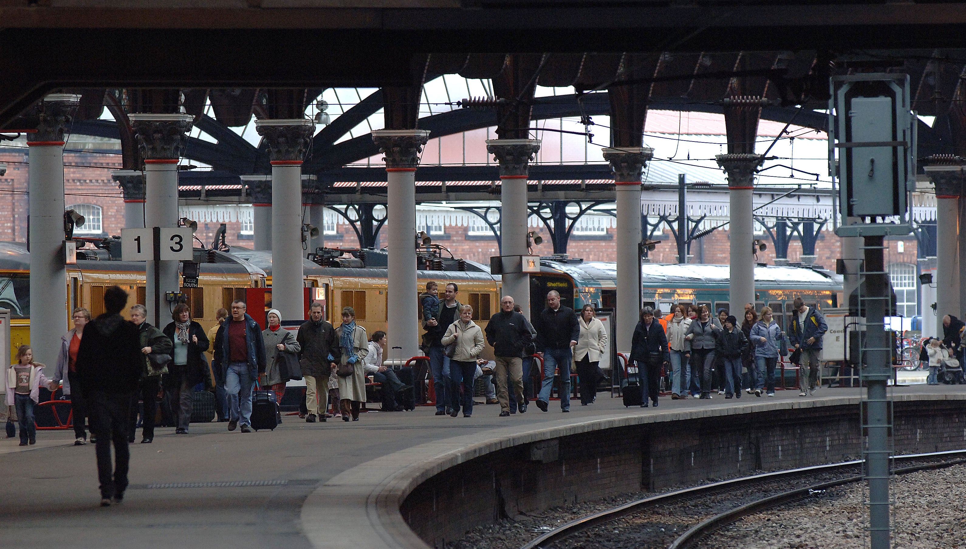 Passengers walk along the platform after alighting from a train at York station (Archive/PA)