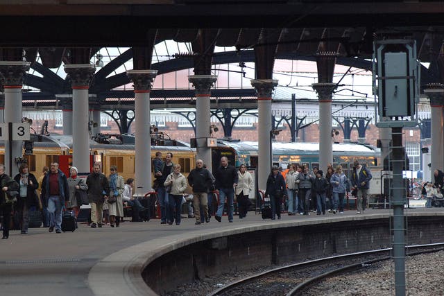 Passengers walk along the platform after alighting from a train at York station (Archive/PA)