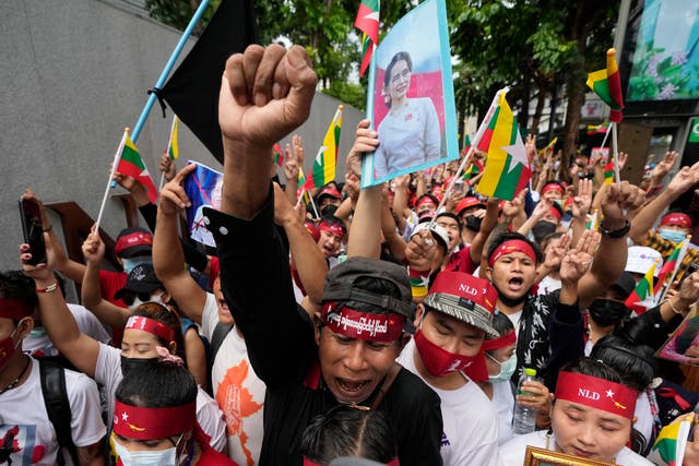 <p>Myanmar nationals living in Thailand with a picture of deposed Myanmar leader Aung San Suu Kyi, seen at center, stage a rally outside Myanmar's embassy in Bangkok, Thailand</p>