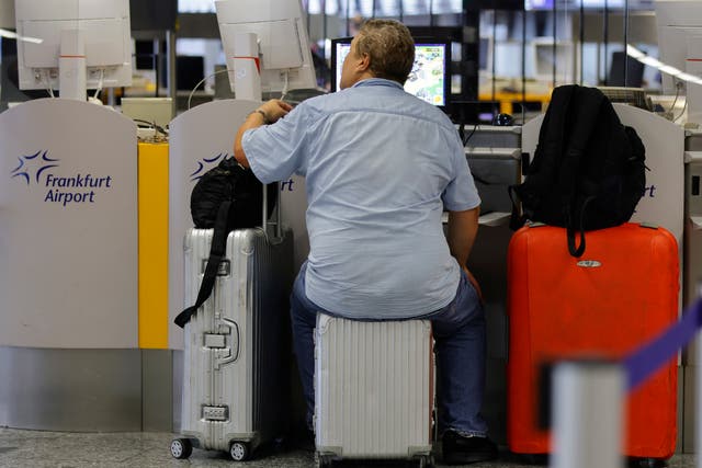 <p>A man waits to check in for a flight at the international airport in Frankfurt, Germany </p>
