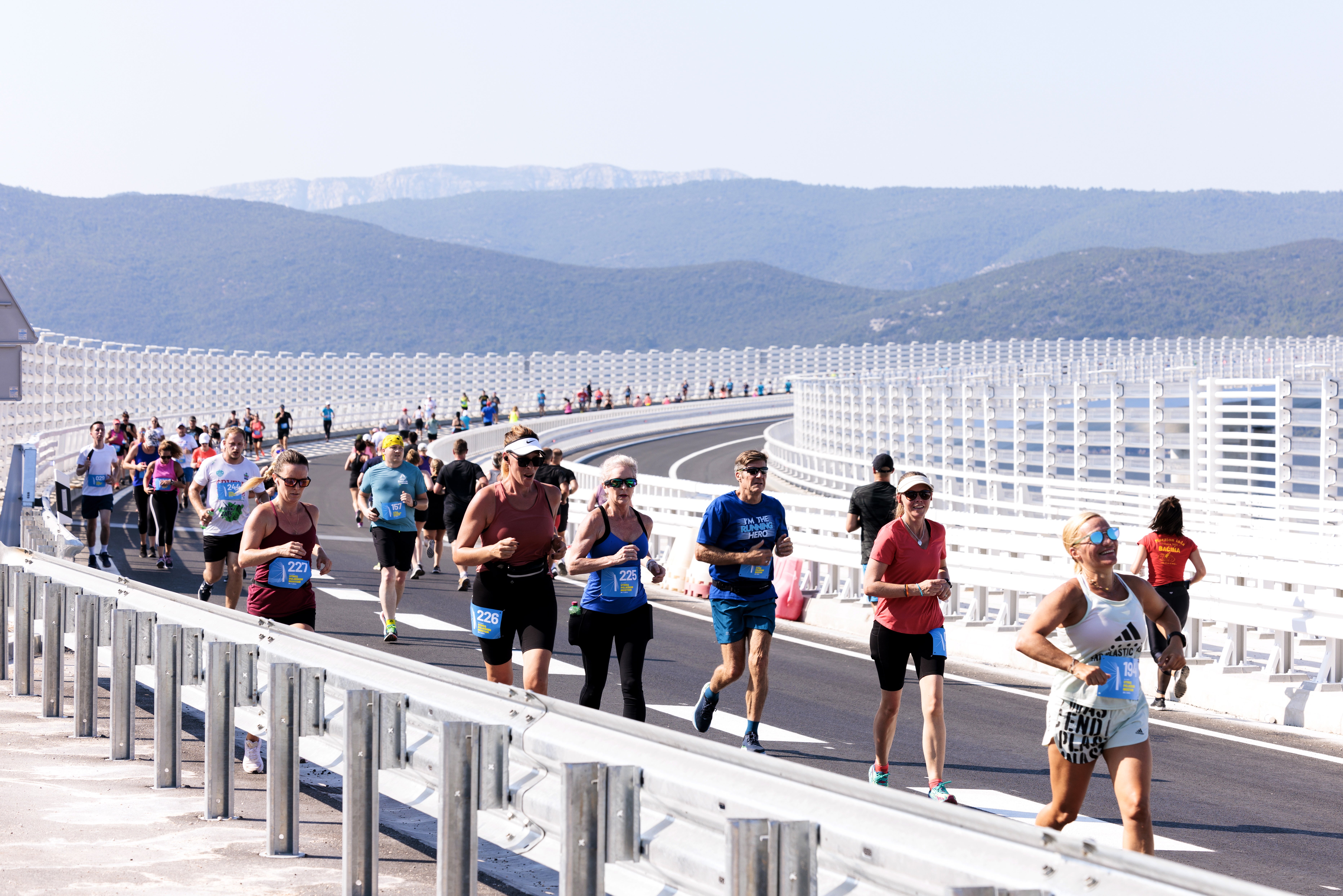 People run over the Peljesac Bridge at Komarna village