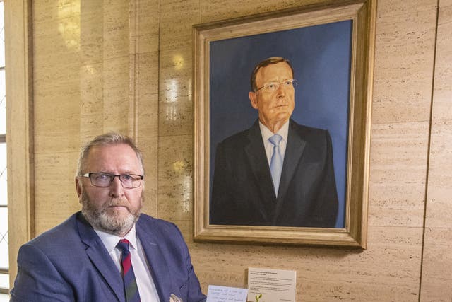 Doug Beattie, leader of the Ulster Unionist Party (UUP) lays a wreath under the portrait of the party’s former leader David Trimble, in the Great Hall of Parliament Buildings at Stormont (Liam McBurney/PA)