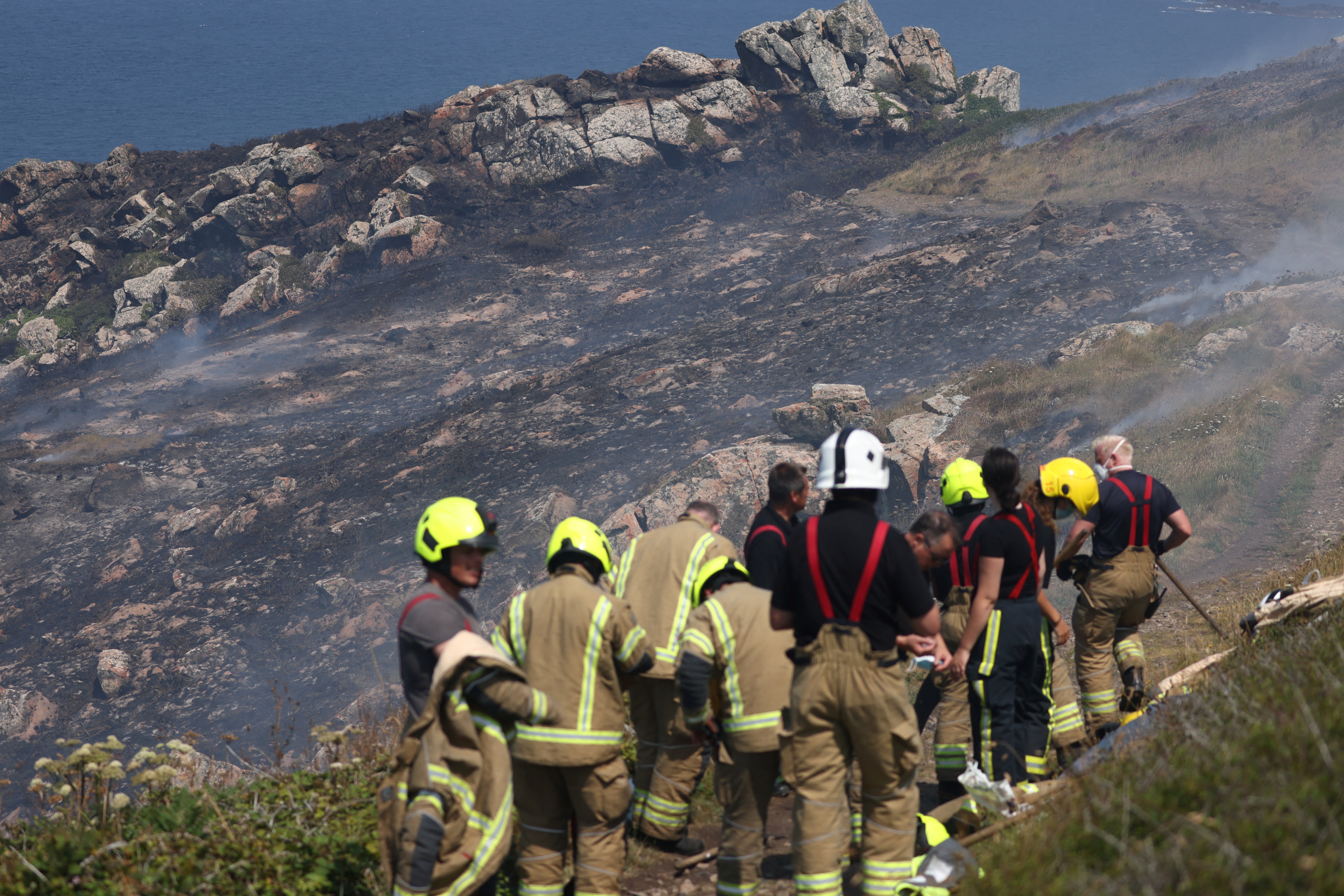 Firefighters attend a gorse bush fire near Zennor, Cornwall
