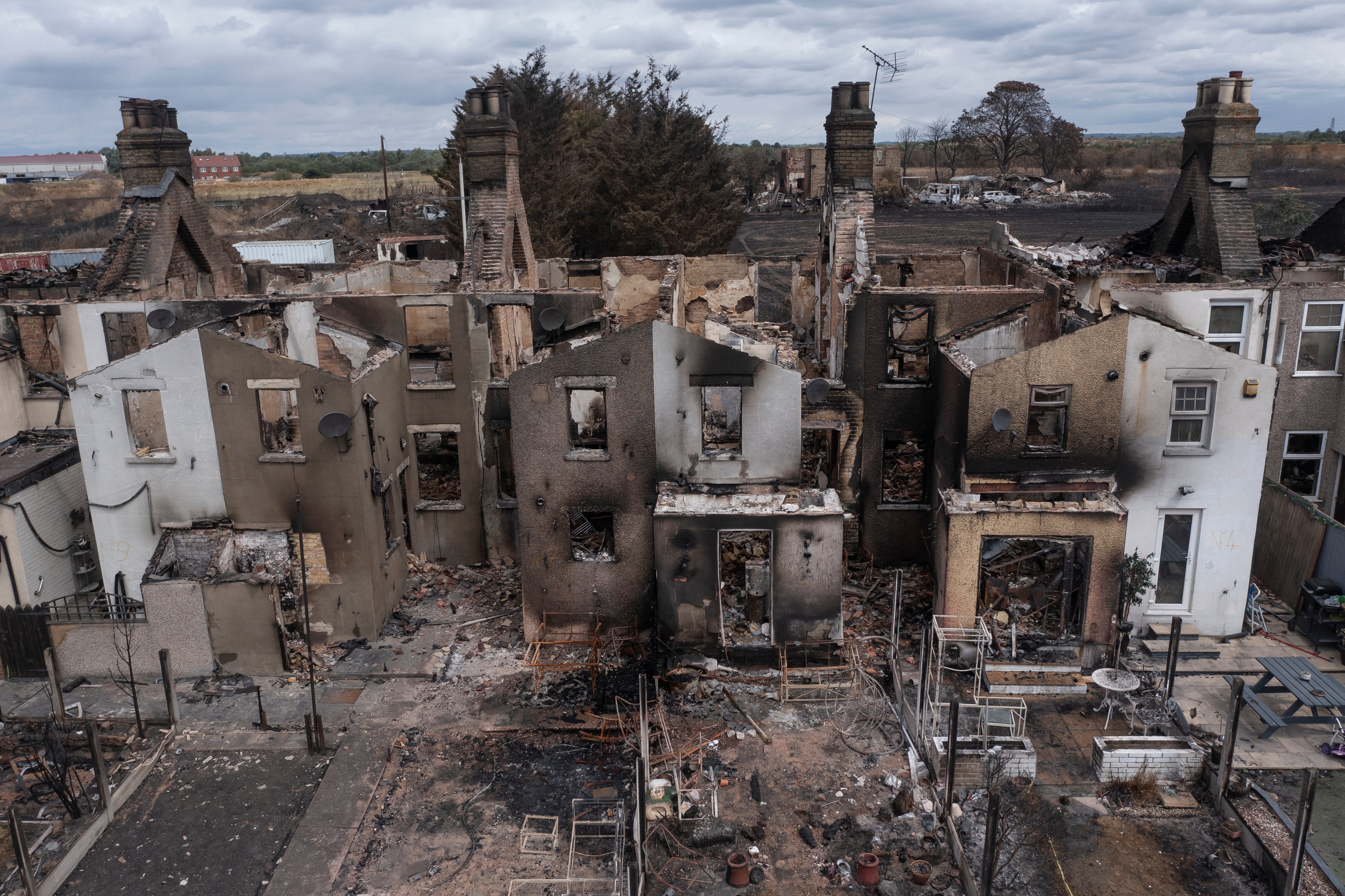 Homes gutted by fire in Wennington, Greater London.