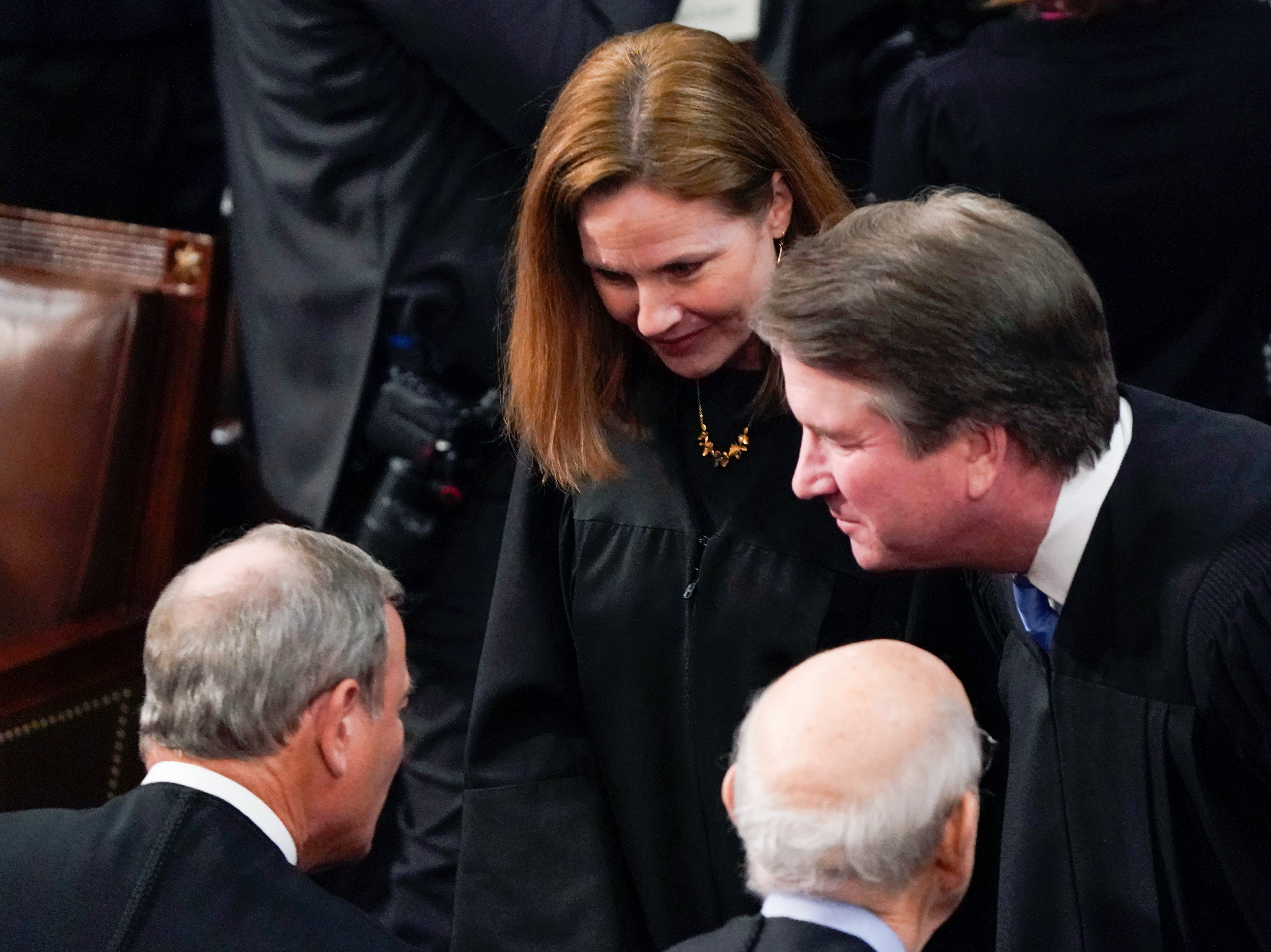 Supreme Court Justices Amy Coney Barrett, Brett Kavanaugh, and Stephen Breyer talk with Chief Justice of the United States John Roberts, left, before President Joe Biden delivers his first State of the Union address