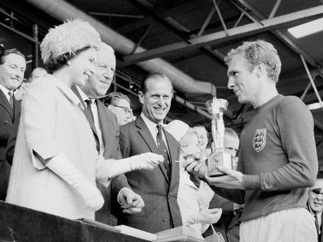 <p>Captain Bobby Moore, right, receives the World Cup trophy from the Queen, left, in 1966</p>