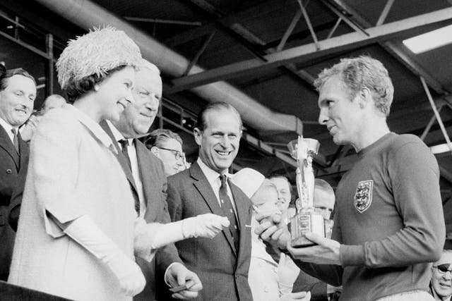 <p>Captain Bobby Moore, right, receives the World Cup trophy from the Queen, left, in 1966</p>