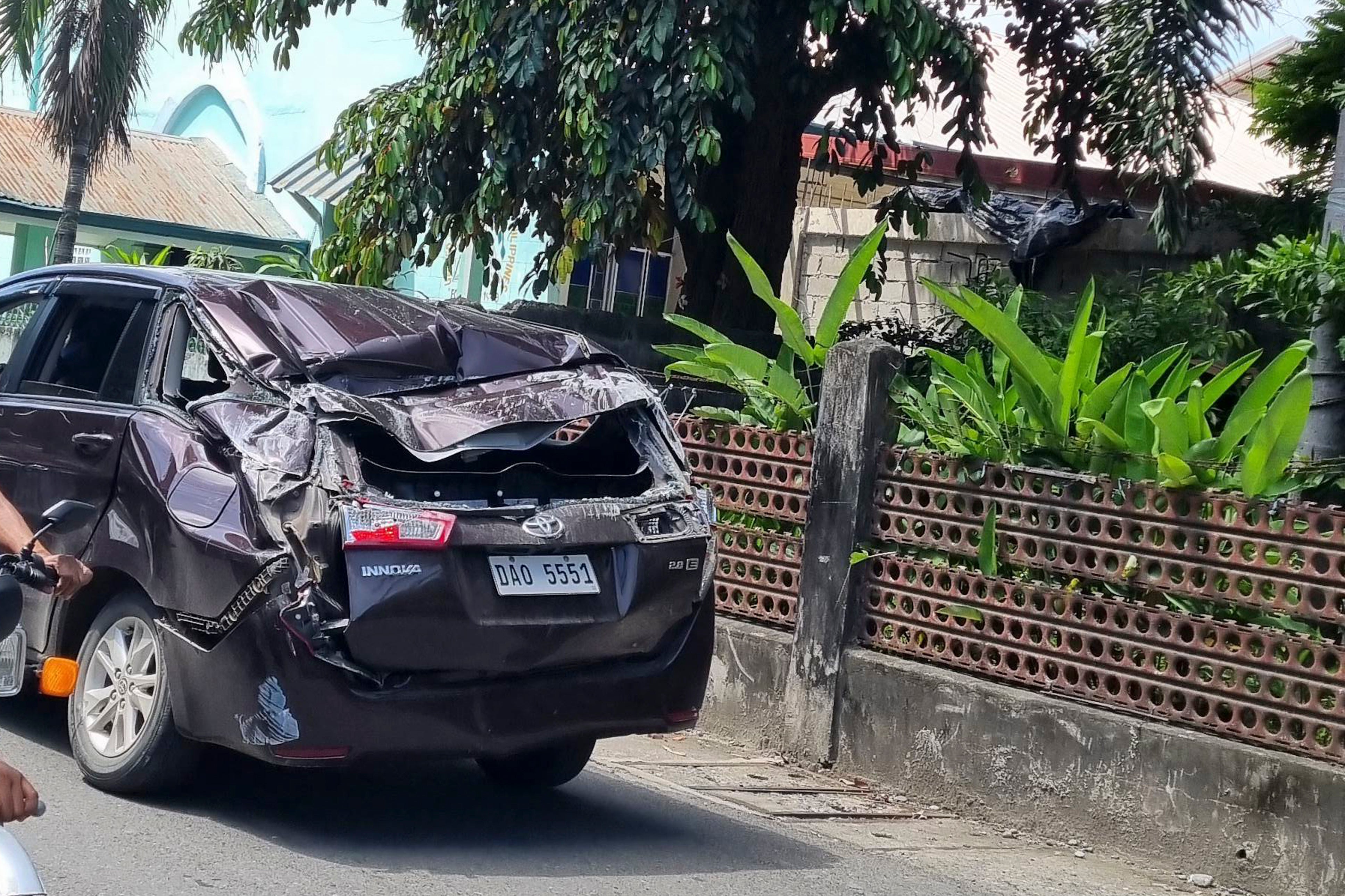 A damaged car is seen along a road after a strong quake hit Bangued, Abra province