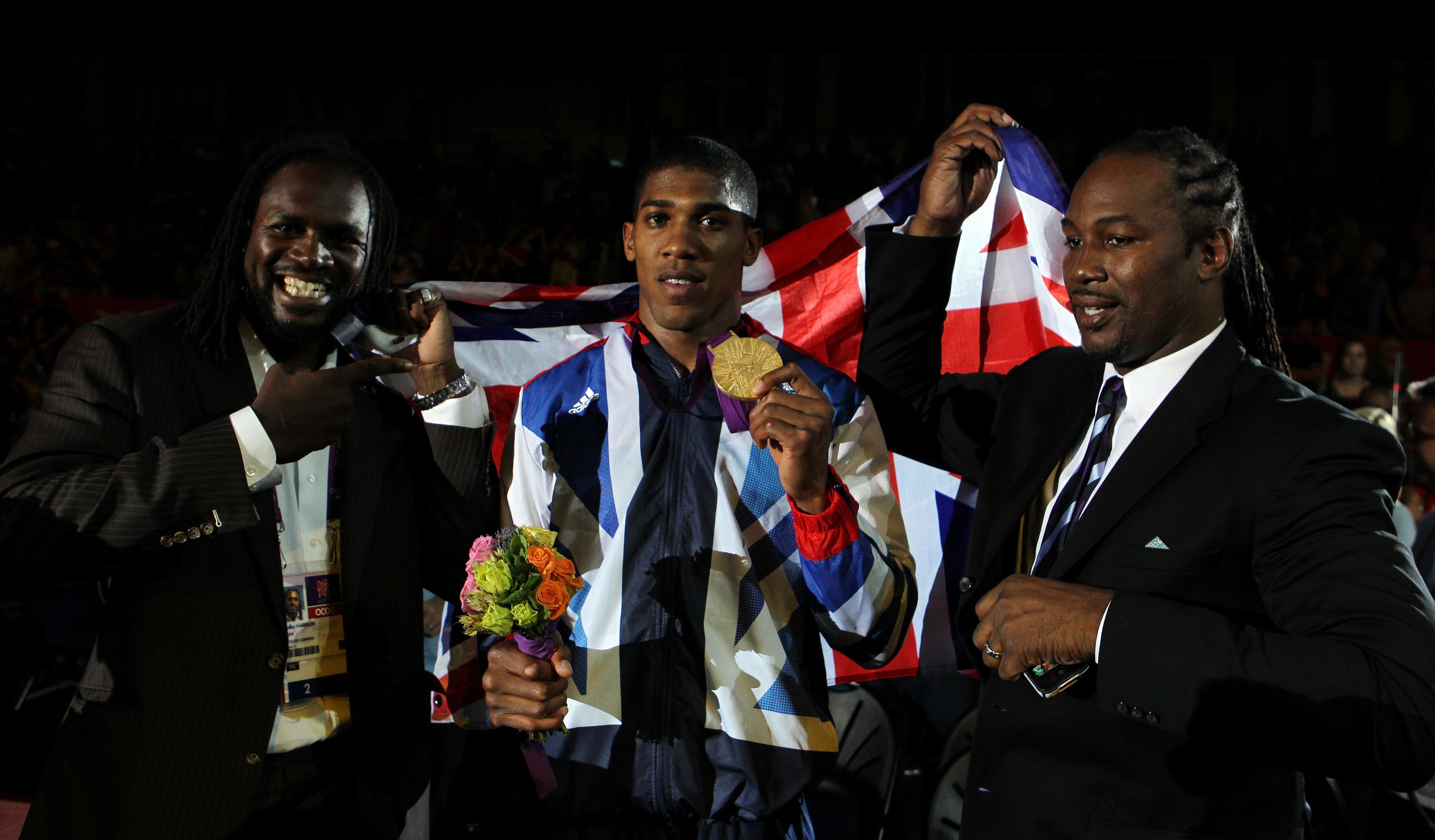 Anthony Joshua (centre) toasted super heavyweight gold with Audley Harrison (left) and Lennox Lewis (Nick Potts/PA)