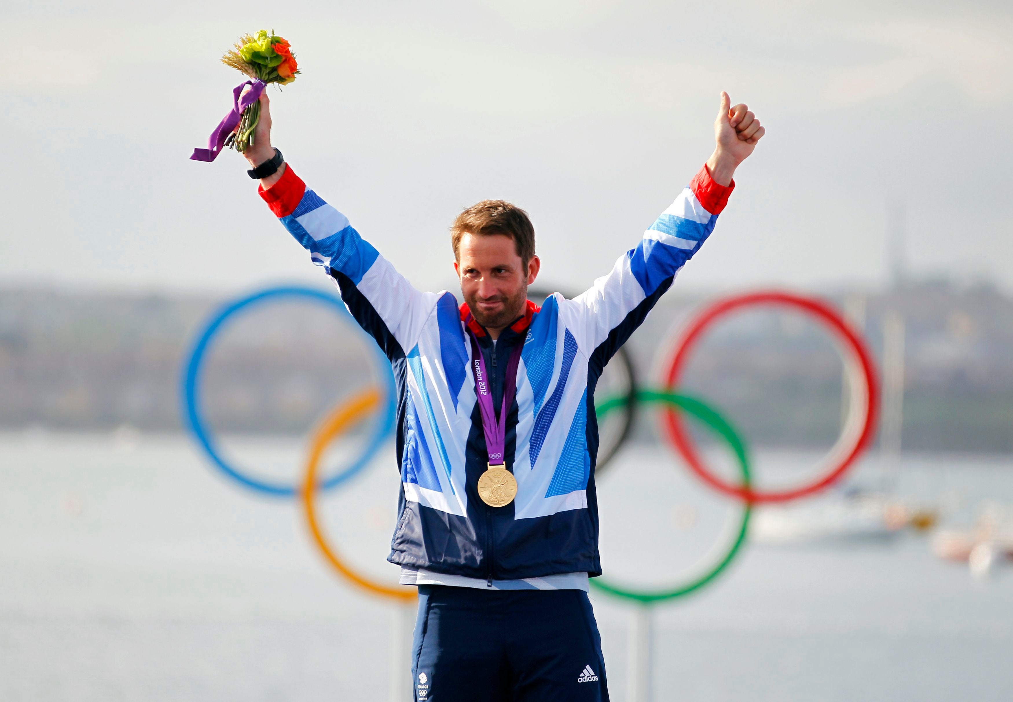 Ben Ainslie celebrated on the podium after winning gold in the Finn class (Chris Ison/PA)