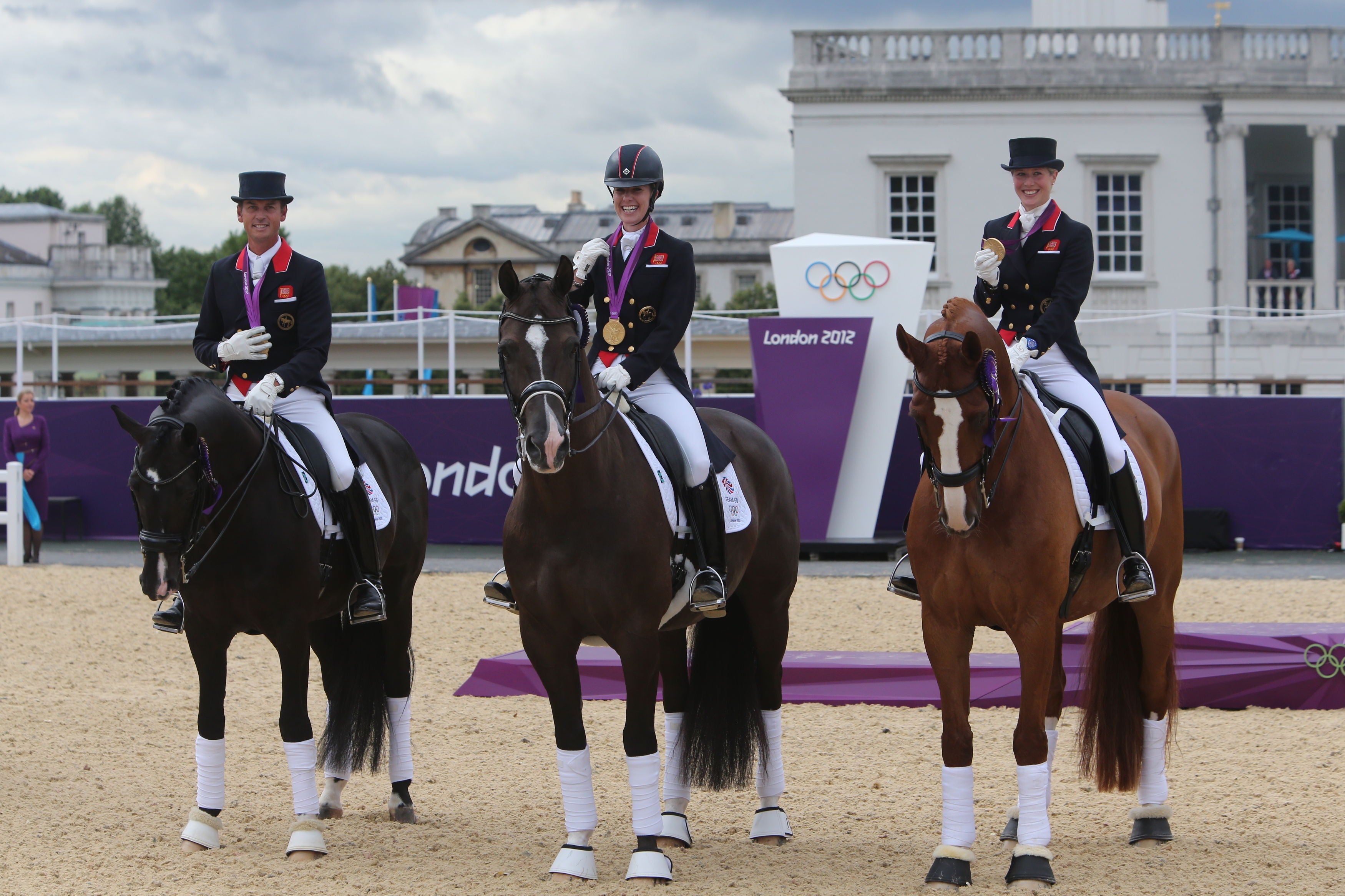 Charlotte Dujardin (centre) won gold in the team dressage with Carl Hester (left) and Laura Bechtolsheimer, plus the individual event (Steve Parsons/PA)