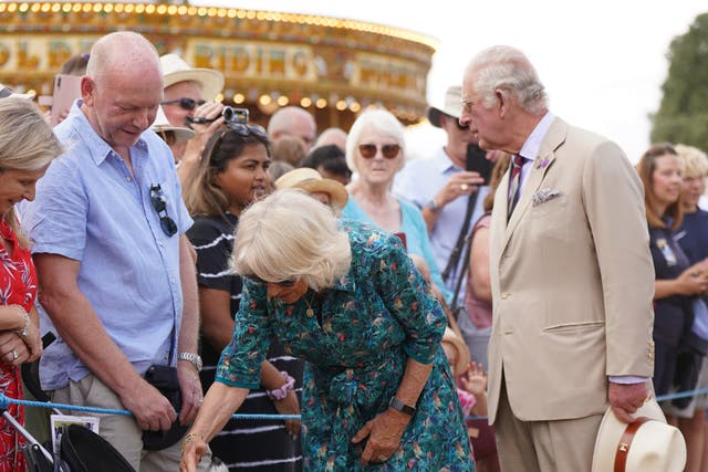 The Duchess of Cornwall stokes Dill, a Jack Russell terrier, as she meets members of the public with the Prince of Wales during their visit and tour of the Sandringham Flower Show (Joe Giddens/ PA)
