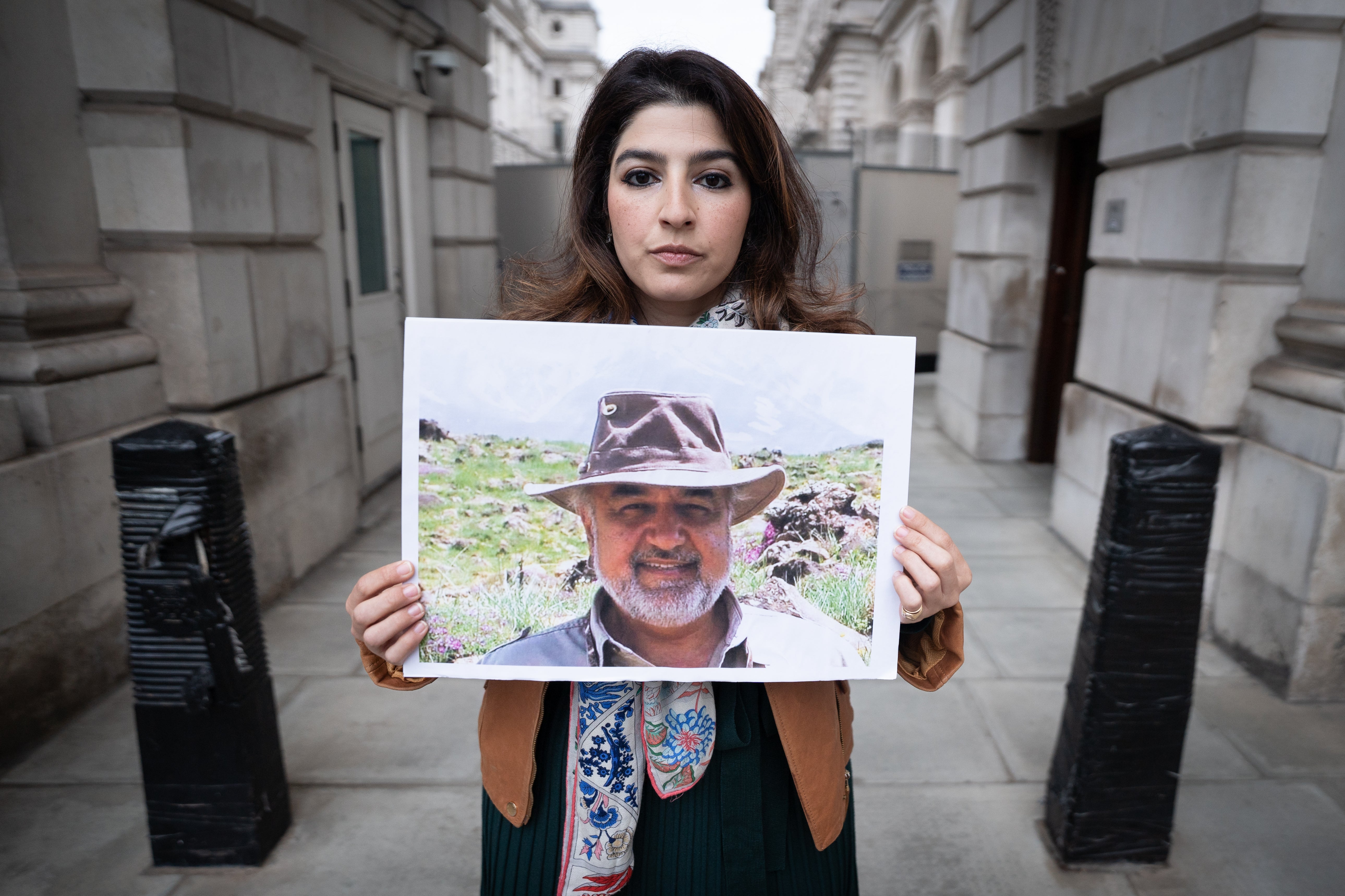 Roxanne Tahbaz, holds a picture of her father Morad Tahbaz, who was jailed in Iran (Stefan Rousseau/PA)