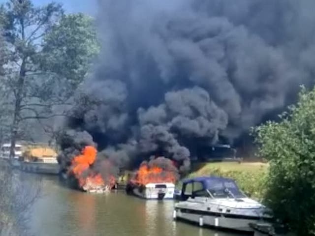 <p>Two people were taken to hospital after a boat erupted into flames before setting several other vessels alight</p>