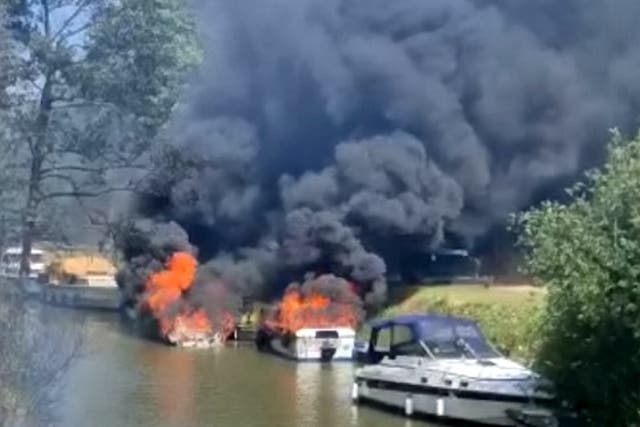 <p>Two people were taken to hospital after a boat erupted into flames before setting several other vessels alight</p>