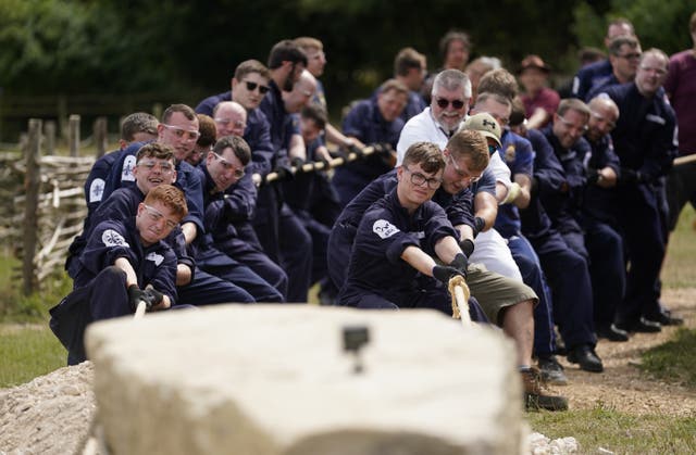 Crew members from HMS Queen Elizabeth and volunteers help move the standing stone (Andrew Matthews/PA)