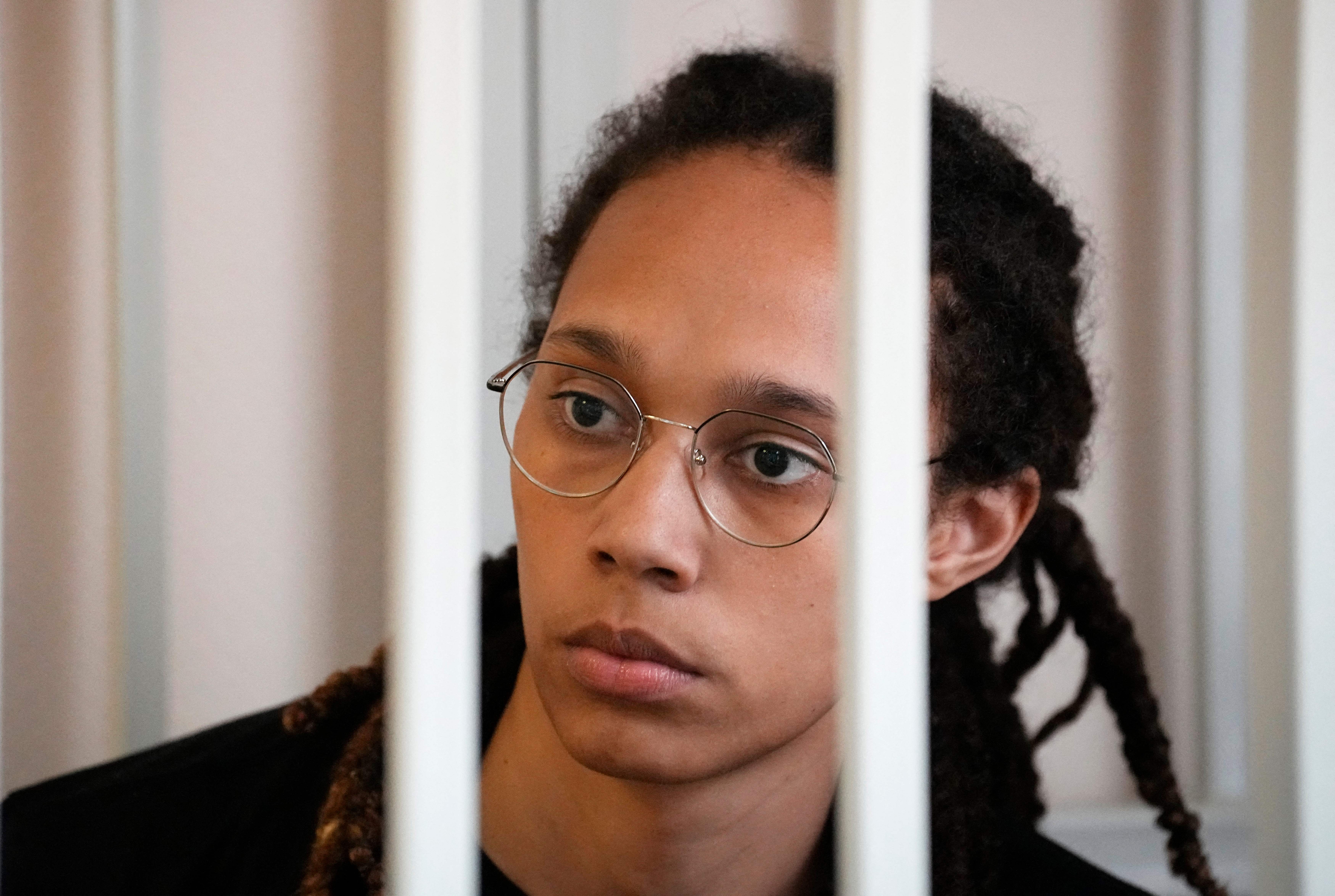 <p>US WNBA basketball superstar Brittney Griner sits inside a defendants' cage before a hearing at the Khimki Court outside Moscow on 27July </p>