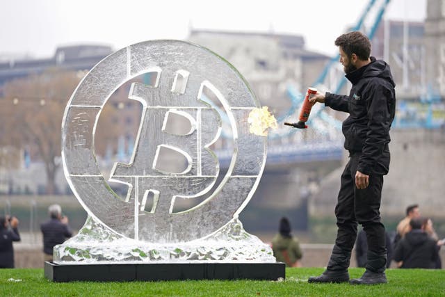 Ice Sculptor Csaba Vass puts the finishing touches to a large Bitcoin ice carving in front of Tower Bridge in London, to celebrate the eighth anniversary of the world’s leading crypto exchange, Huobi Global. Picture date: Wednesday November 24, 2021.
