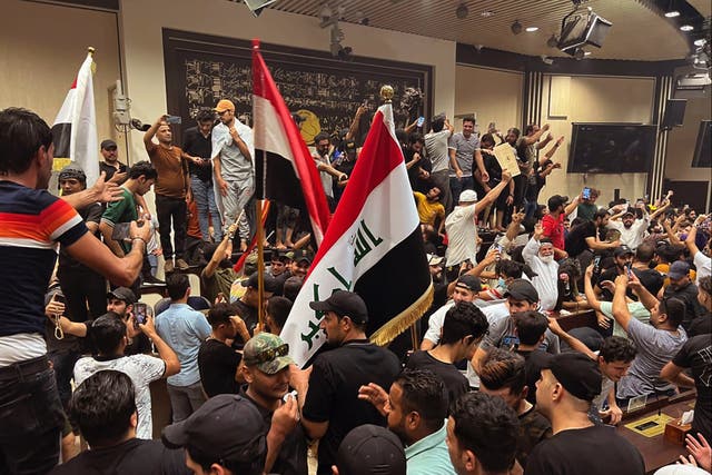 <p>Iraqi protesters breach Baghdad’s parliament on Wednesday 27 July 2022</p>