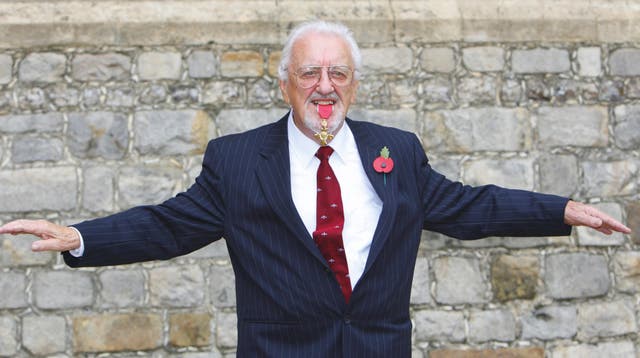 Bernard Cribbins with his OBE medal after receiving it during an investiture ceremony in 2011 (PA)