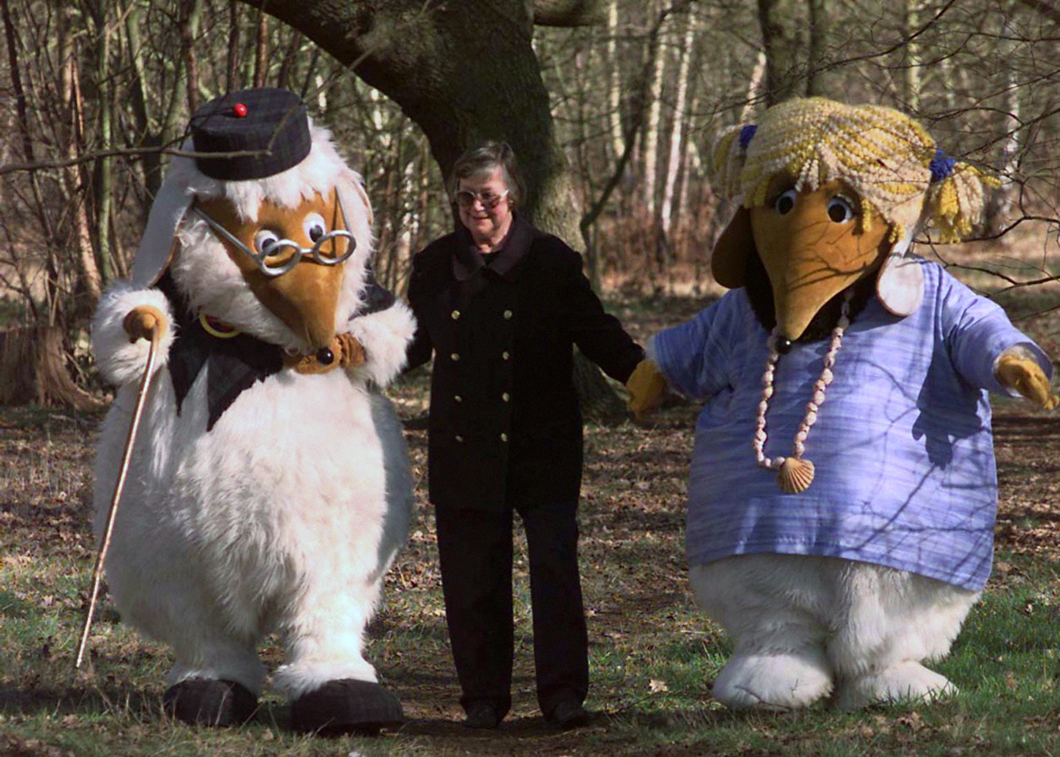 Elisabeth Beresford walks with Wombles Uncle Bulgaria and Alderney in the woods of Wimbledon Common (PA)