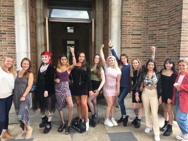 Strip club workers celebrate on the steps of Bristol City Hall after the council voted against banning the venues (PA)