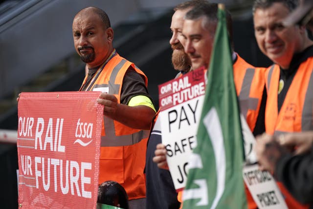 <p>Members of the TSSA and RMT on the picket line outside London Euston </p>