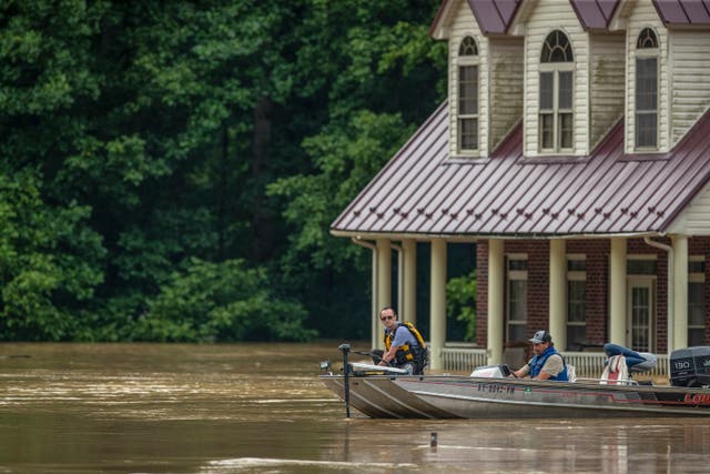 <p>People take a boat through Lost Creek, Kentucky, which flooded as intense storms hit the region</p>