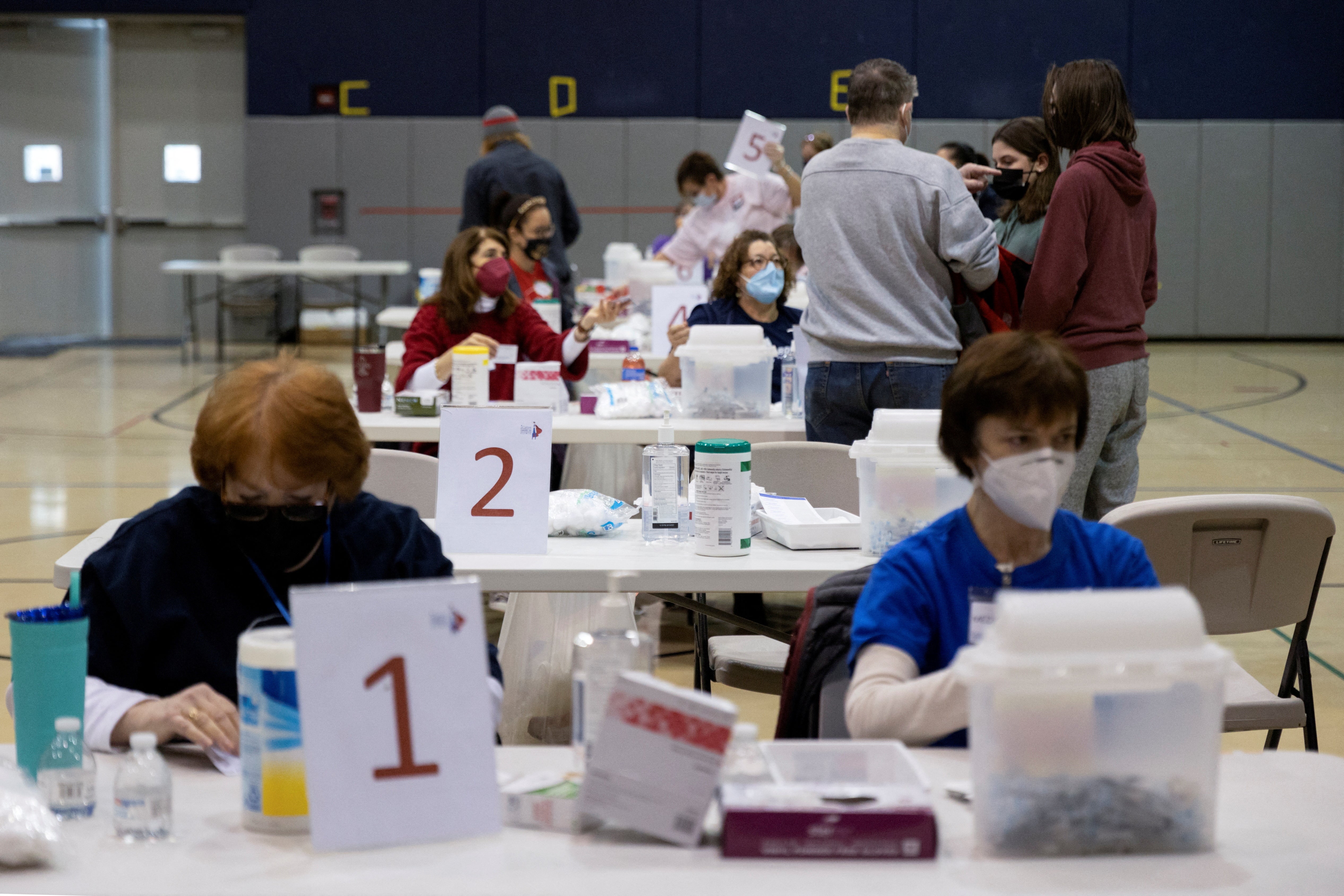 <p>Healthcare workers prepare to distribute doses of the Pfizer-BioNTech vaccine against Covid.  </p>