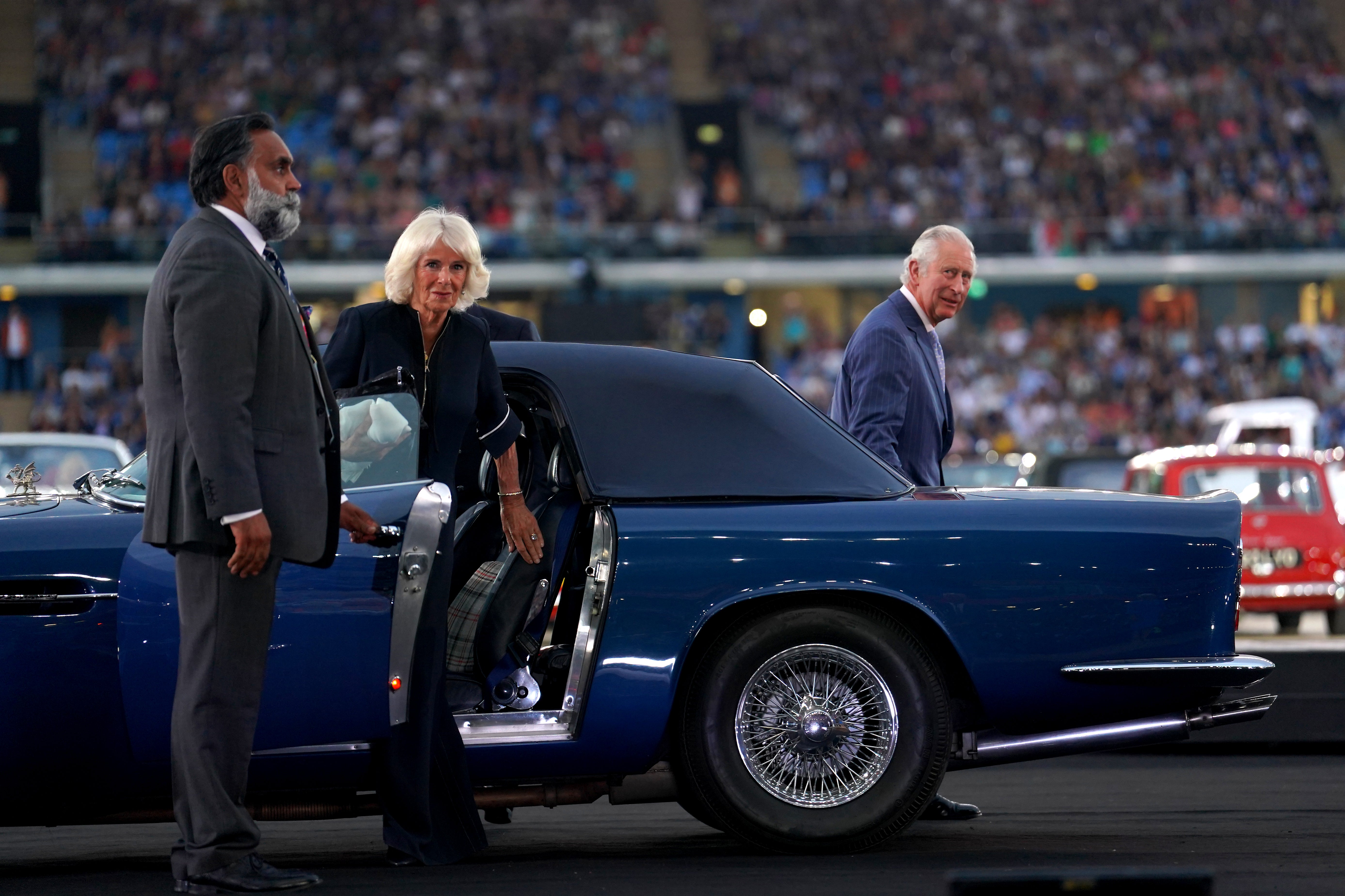 The Prince of Wales and the Duchess of Cornwall arrive in an Aston Martin during the opening ceremony (David Davies/PA)