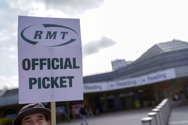 Members of the Rail, Maritime and Transport union (RMT) on the picket line outside Reading railway station (Steve Parsons/PA)