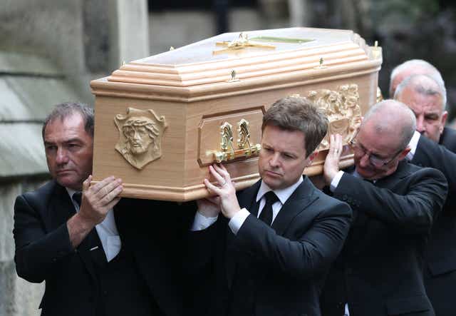 Declan Donnelly carries the coffin of his brother, Father Dermott Donnelly, into St Mary’s Cathedral in Newcastle (Scott Heppell/PA)