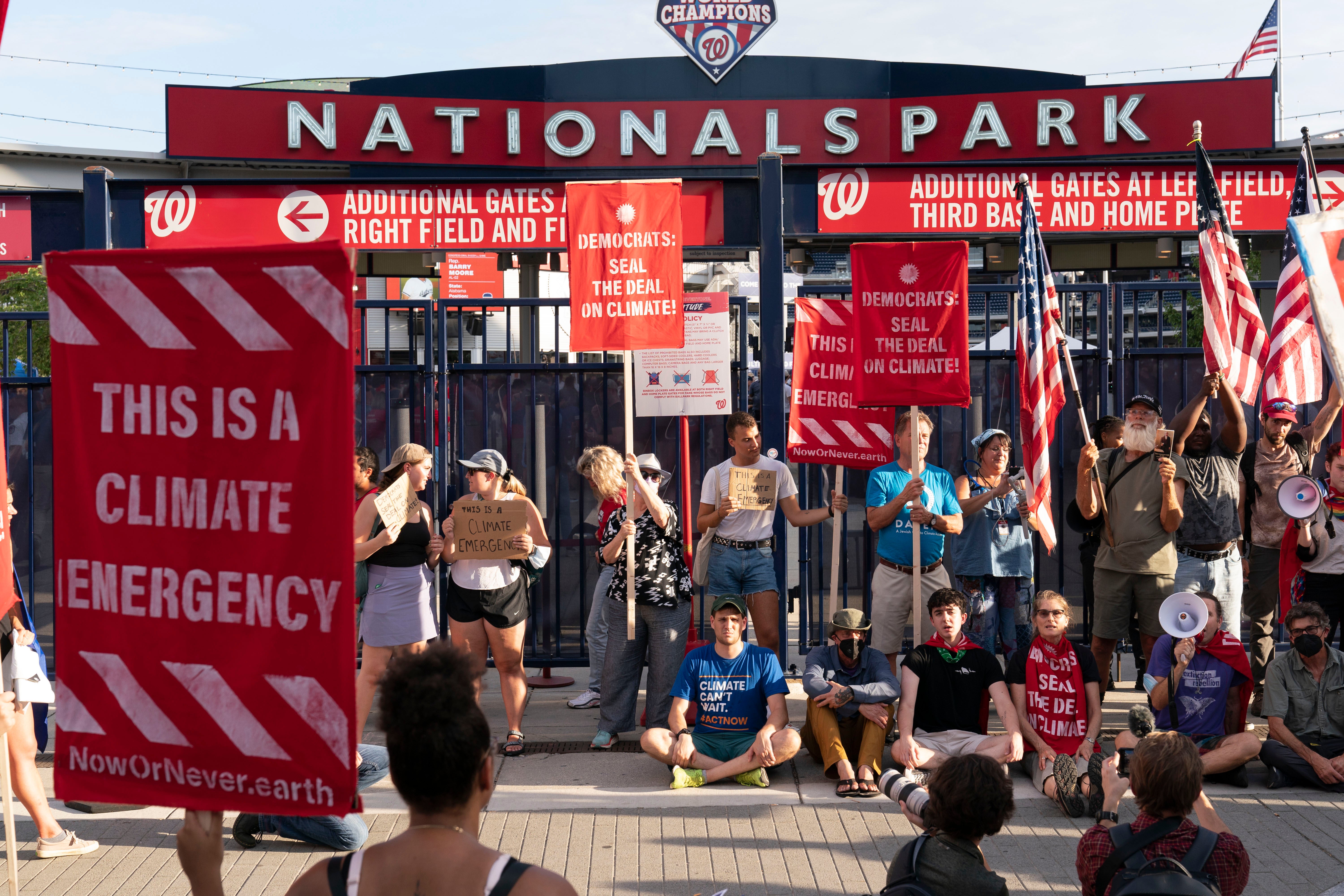 Climate activists protest outside Nationals Park and try to block an entry gate, where the annual Congressional Baseball Game for Charity is being held