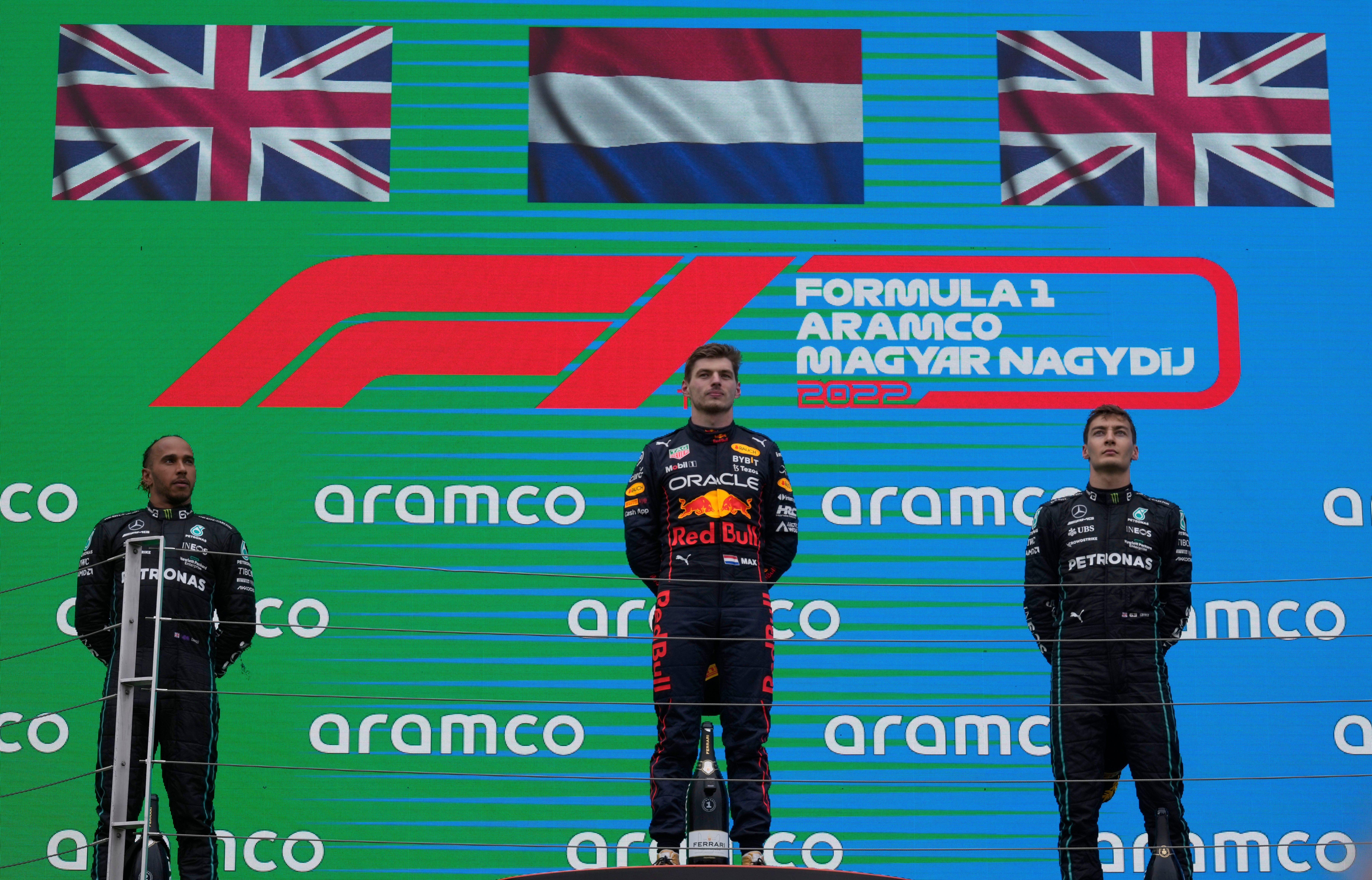 Max Verstappen (centre), stands on the podium with Lewis Hamilton (left) and George Russell (Darko Bandic/AP)