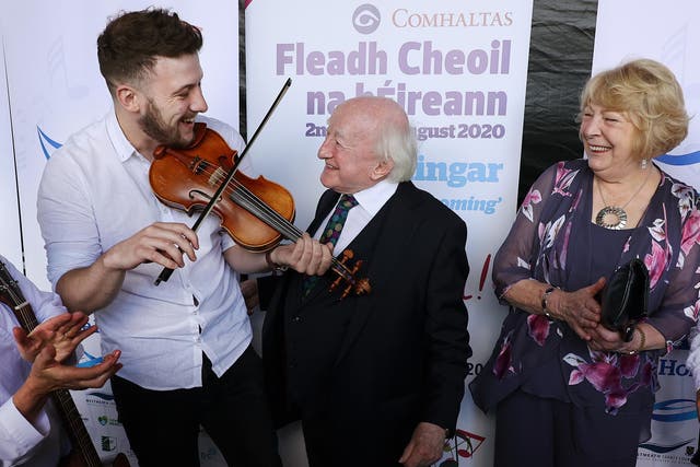 President Michael D Higgins and his wife Sabina with musician Daniel Boland (PA)