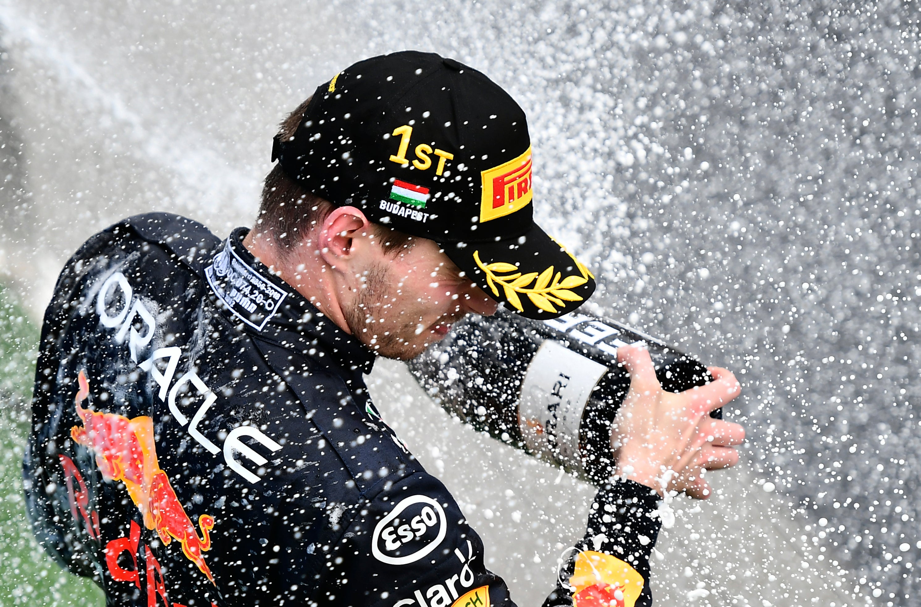 Max Verstappen of the Netherlands sprays champagne on the podium after winning the Hungarian Grand Prix (Anna Szilagyi/AP)