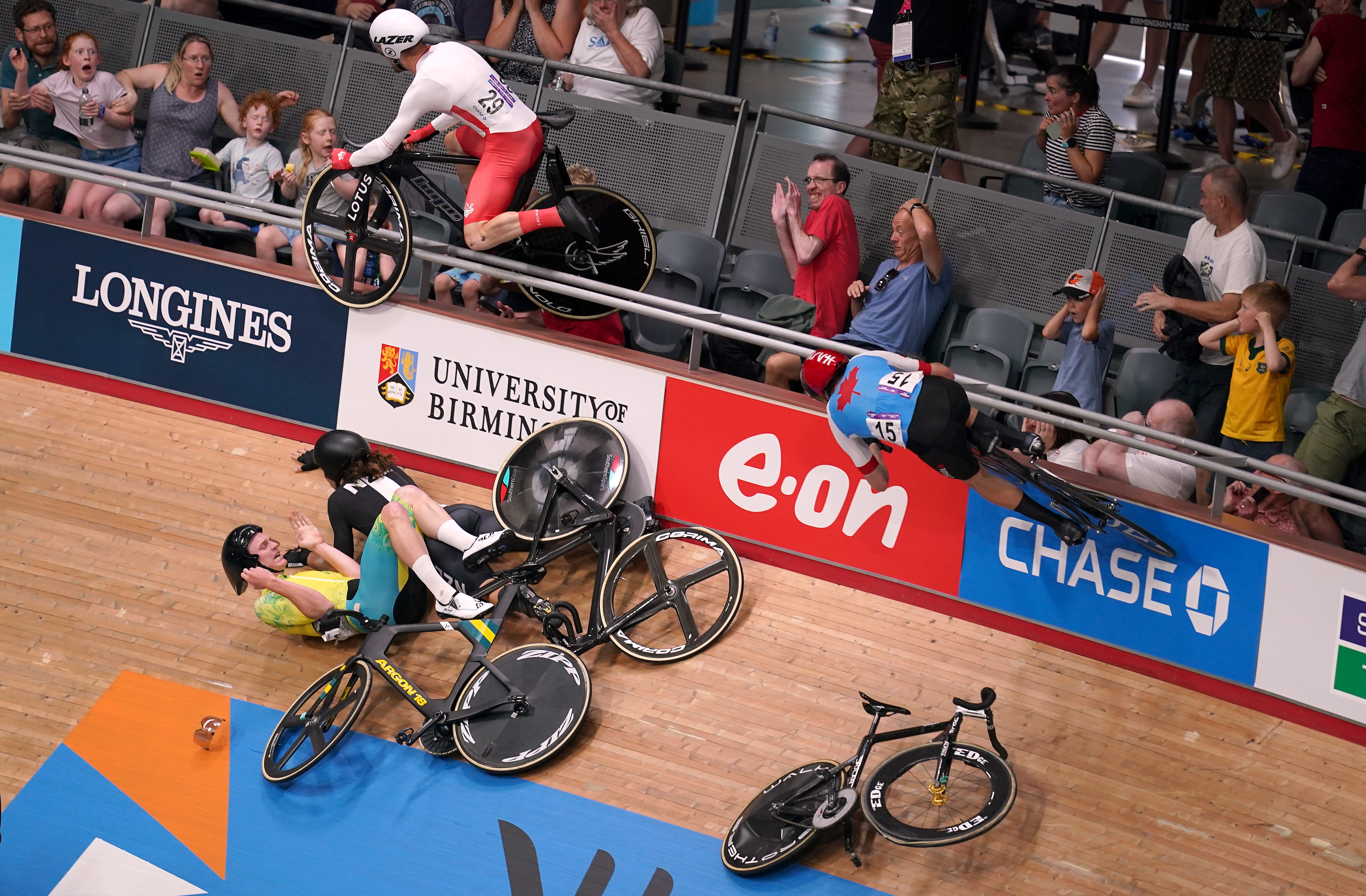 England’s Matt Walls goes over the barrier into the crowd after a crash in the Men’s 15km Scratch Race Qualifying Round at the Commonwealth Games (John Walton/PA)