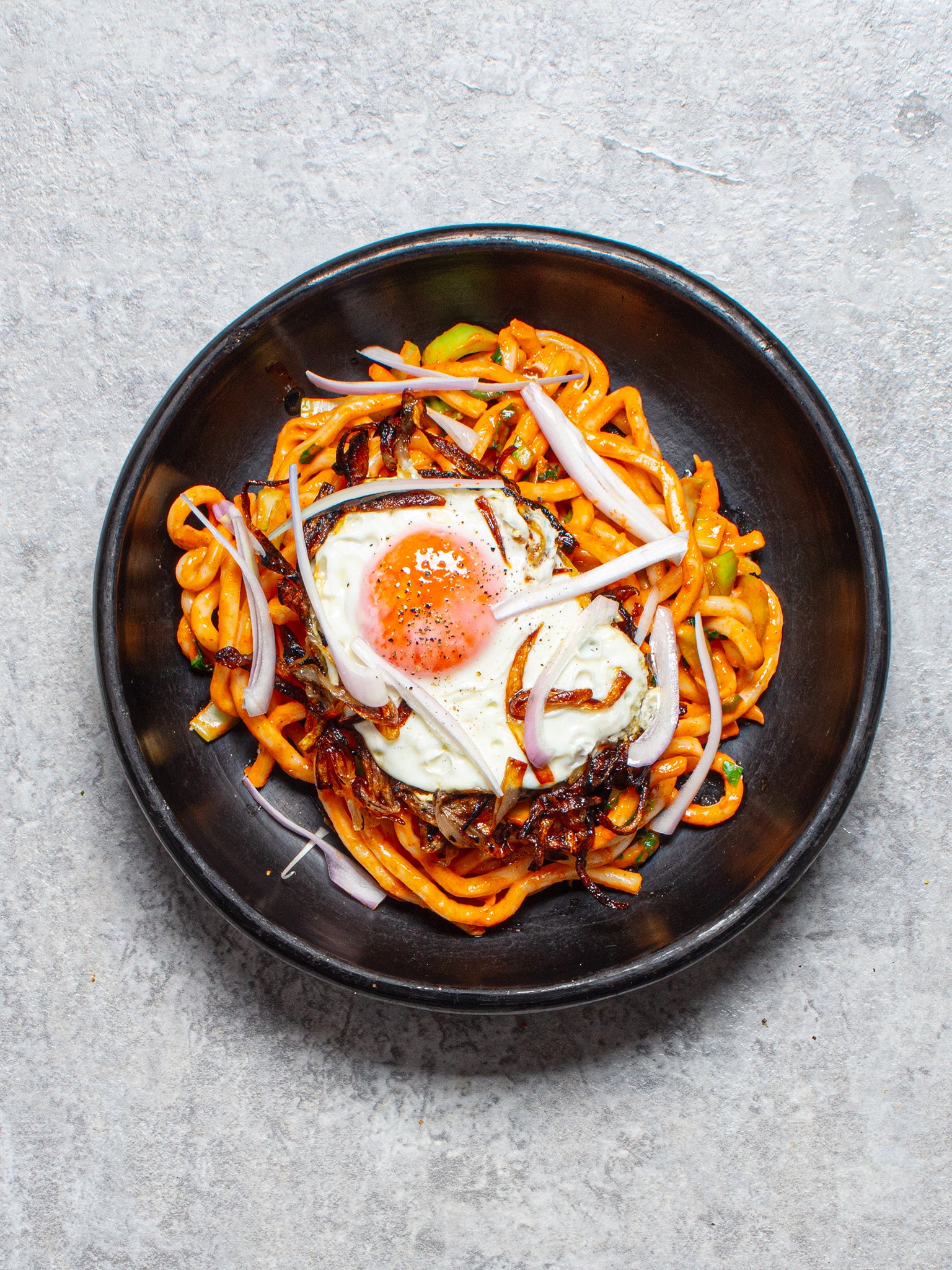 A fried egg with crispy, onion-y edges is the perfect complement to these spicy noodles