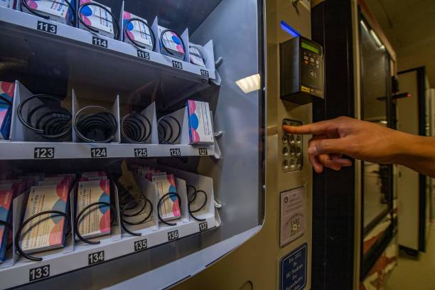 <p>A person demonstrates how to purchase a carton out of the "morning-after" pill, Plan-B, vending machine that sits in the basement of the student union building on the Boston University Campus in Boston</p>