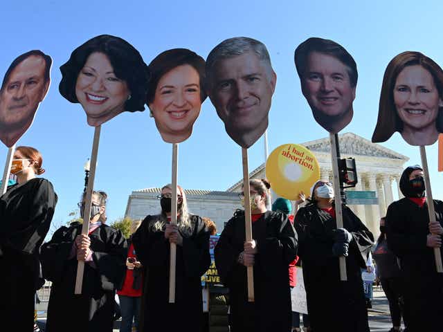 <p>Abortion rights activists carry cutouts of members of the Supreme Court</p>